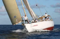 Sailing yacht Devonport Challenge 67, 1995 model, navigating ocean waters with crew on deck.