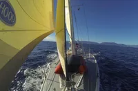 Sailing on a 1995 Devonport Challenge 67 yacht with yellow sails in open sea.