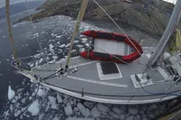 Sailboat "Devonport Challenge 67" navigating icy waters near rocky shoreline, 1995 model.