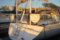 Sailing yacht Devonport Challenge 67, 1995 model, docked in a marina at sunset.