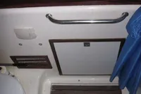 Bathroom interior of 1995 Devonport Challenge 67 yacht with sink and wooden floor.