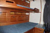 Interior of 1995 Devonport Challenge 67 yacht with wooden bunk beds and storage.