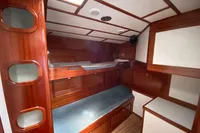 Interior of 1995 Devonport Challenge 67 yacht with wooden bunk beds and storage.