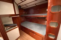 Interior of 1995 Devonport Challenge 67 yacht with wooden bunk beds and storage.