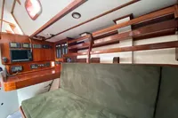 Interior of 1995 Devonport Challenge 67 yacht with green seating and navigation equipment.