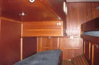 Interior cabin of 1995 Devonport Challenge 67 yacht with wooden paneling and bunk beds.