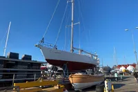 Devonport Challenge 67 sailboat from 1995 on a dock under clear blue sky.