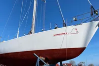Sailboat "Nashachata II" on land, Devonport Challenge 67, 1995 model, clear blue sky.