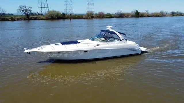  Yacht Photos Pics 2001 Sea Ray 460 Sundancer yacht cruising on a calm river.