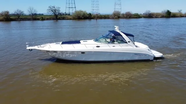  Yacht Photos Pics 2001 Sea Ray 460 Sundancer yacht cruising on a calm river.