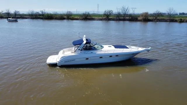  Yacht Photos Pics 2001 Sea Ray 460 Sundancer yacht cruising on a calm river.