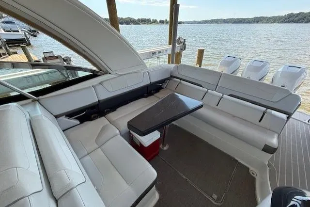  Yacht Photos Pics 2018 Formula 350 Crossover Bowrider OB interior with seating and table, overlooking a serene lake.