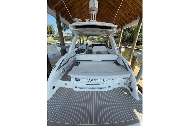  Yacht Photos Pics 2018 Formula 350 Crossover Bowrider OB docked under a wooden canopy.