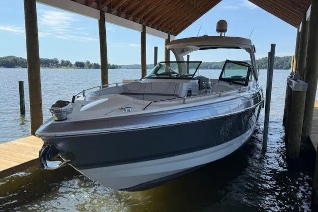  Yacht Photos Pics 2018 Formula 350 Crossover Bowrider OB docked under a wooden shelter.