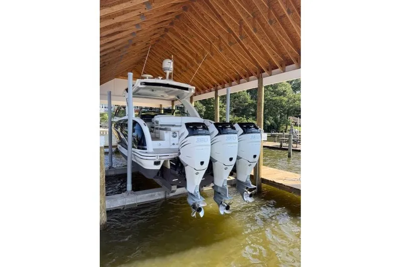  Yacht Photos Pics 2018 Formula 350 Crossover Bowrider OB with triple outboard engines in a covered dock.