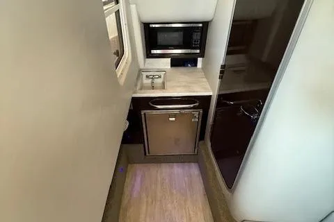  Yacht Photos Pics 2018 Formula 350 Crossover Bowrider OB interior with kitchenette, microwave, and compact fridge.