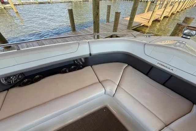  Yacht Photos Pics 2018 Formula 350 Crossover Bowrider OB interior with plush seating near a dock.