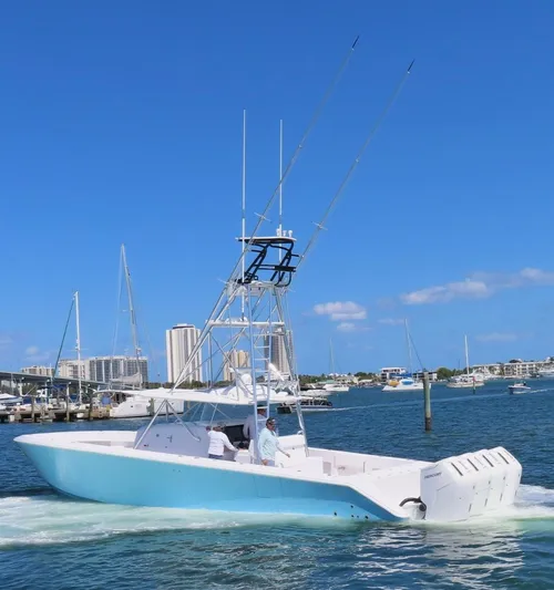  Yacht Photos Pics 2023 Sparks 46 boat cruising in a marina with cityscape background.