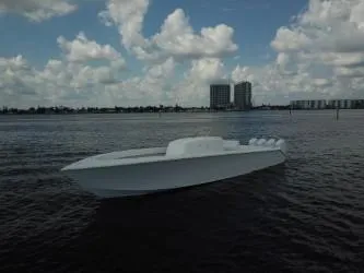  Yacht Photos Pics Sleek 2025 Sparks 46 boat on calm water under a cloudy sky.