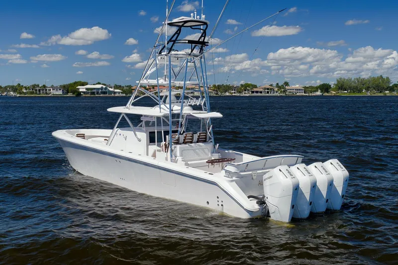  Yacht Photos Pics 2026 Sparks 46 boat with four engines on a sunny day, cruising on a calm lake.