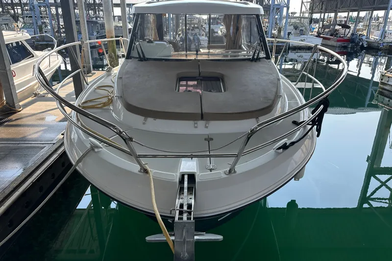 Makai Yacht Photos Pics 2016 Jeanneau Merry Fisher 855 docked in a marina, front view.