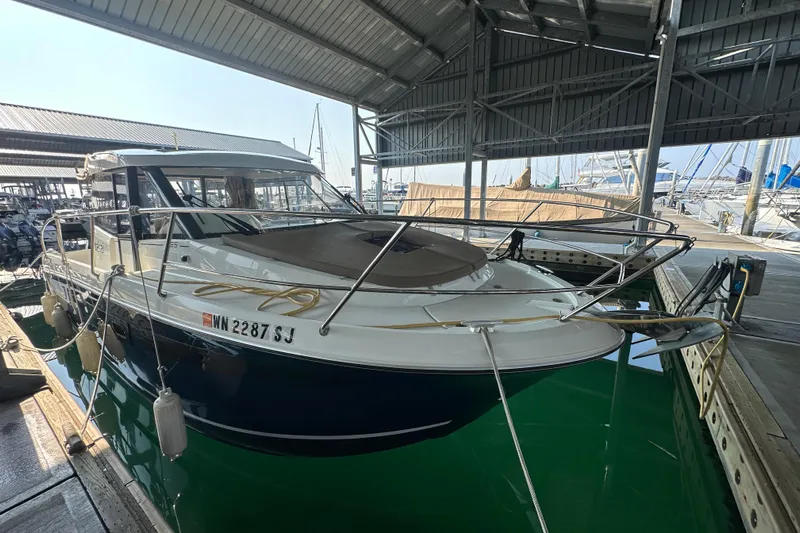 Makai Yacht Photos Pics 2016 Jeanneau Merry Fisher 855 docked in a covered marina.