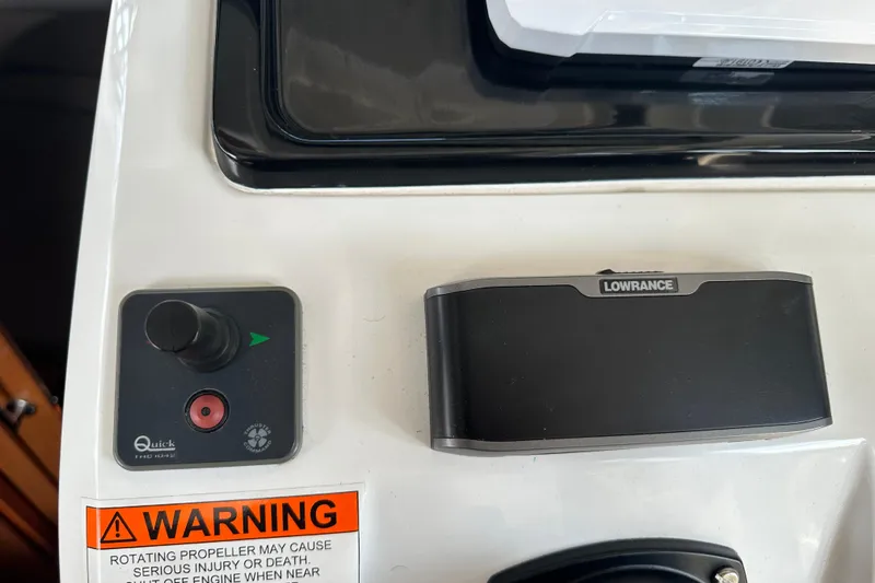Makai Yacht Photos Pics Control panel of 2016 Jeanneau Merry Fisher 855 with Lowrance device and warning label.