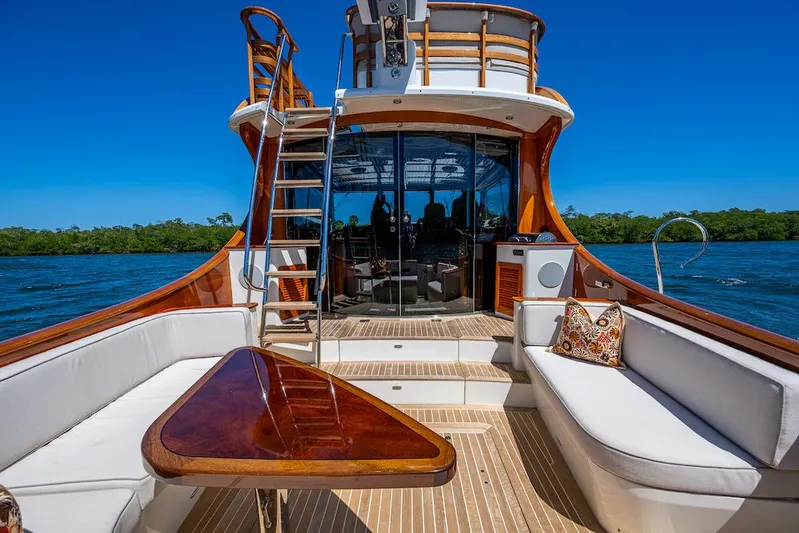 Vera North Yacht Photos Pics Luxurious 2021 Hinckley Talaria 55 Flybridge MKII yacht with elegant seating and scenic water view.