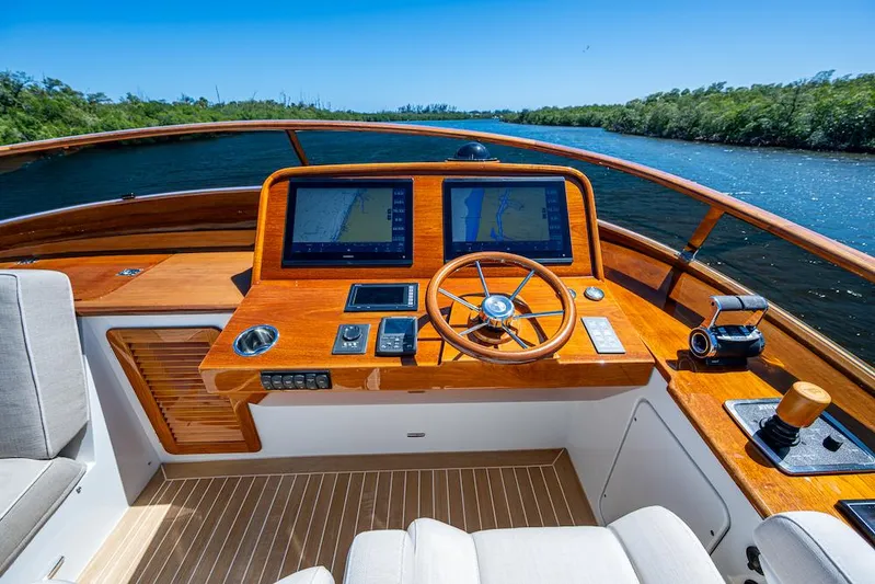 Vera North Yacht Photos Pics Helm of 2021 Hinckley Talaria 55 Flybridge MKII with dual screens and wooden steering wheel.
