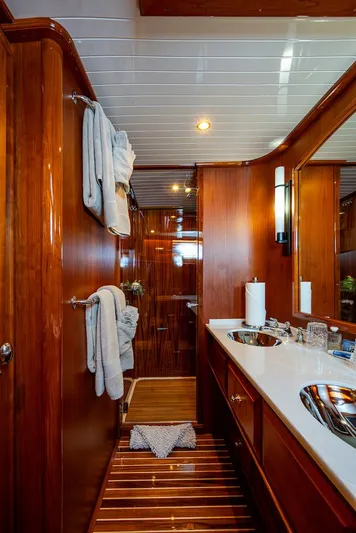 Vera North Yacht Photos Pics Luxurious bathroom in 2021 Hinckley Talaria 55 Flybridge MKII yacht, featuring elegant wood finishes.