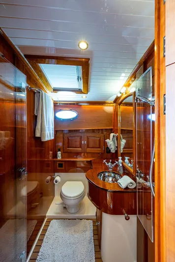 Vera North Yacht Photos Pics Luxurious bathroom in 2021 Hinckley Talaria 55 Flybridge MKII yacht with wood accents and modern fixtures.