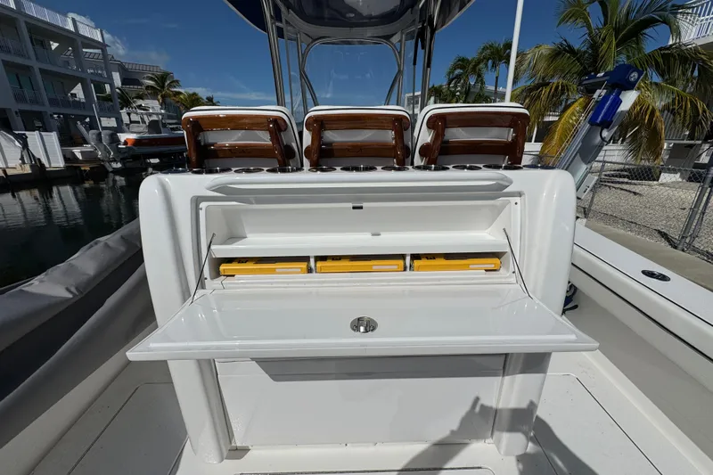  Yacht Photos Pics 2024 Valhalla V-29 Hybrid boat with open storage compartment and seating, dockside view.