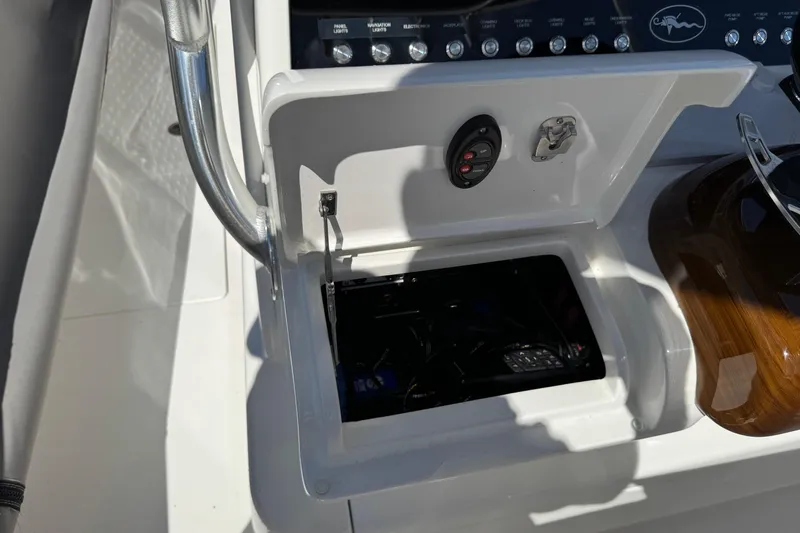  Yacht Photos Pics 2024 Valhalla V-29 Hybrid boat console with open storage compartment and control panel.