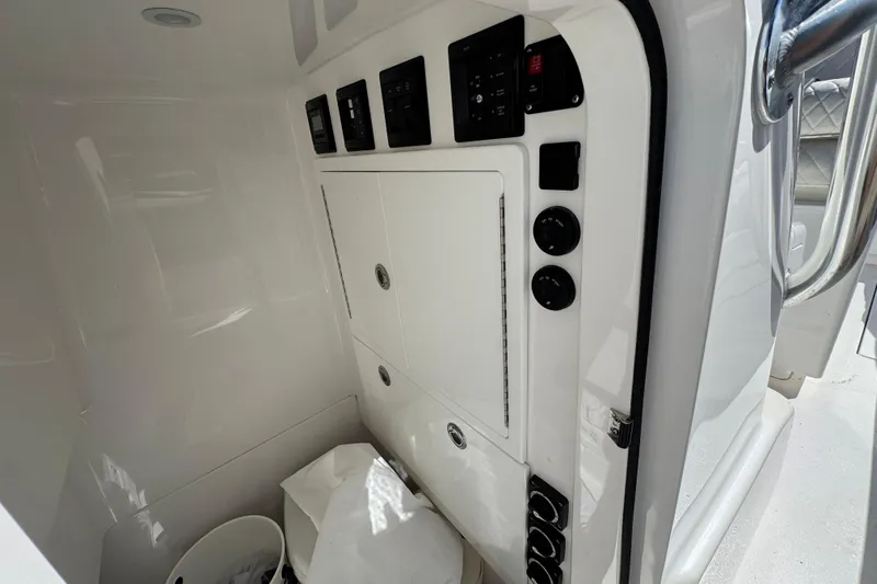  Yacht Photos Pics 2024 Valhalla V-29 Hybrid boat interior with control panel and storage compartment.