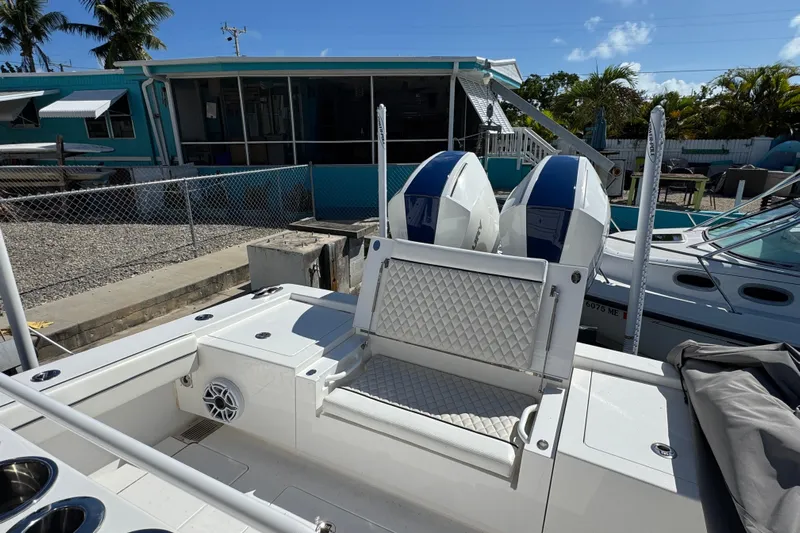  Yacht Photos Pics 2024 Valhalla Boatworks V-29 Hybrid with dual engines, docked near a turquoise building.