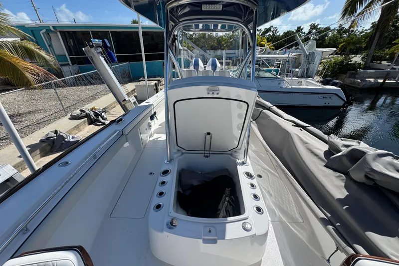  Yacht Photos Pics 2024 Valhalla Boatworks V-29 Hybrid with open storage compartment, docked near other boats.