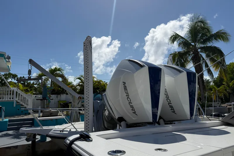  Yacht Photos Pics 2024 Valhalla V-29 Hybrid boat with twin Mercury engines, docked under a clear blue sky.