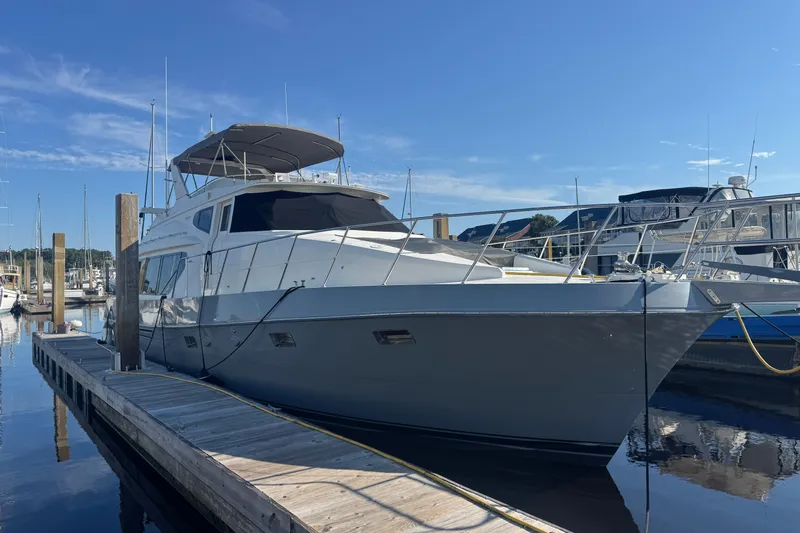 Baby Girl Yacht Photos Pics 1999 McKinna 57 Pilothouse yacht docked at marina under clear blue sky.
