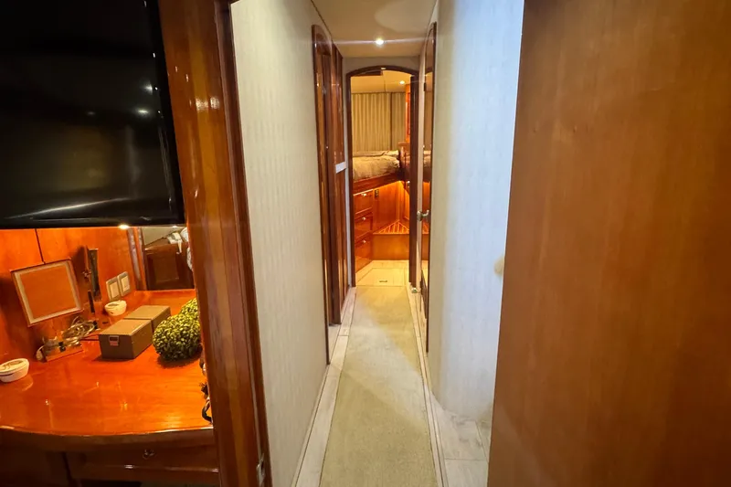 Baby Girl Yacht Photos Pics Hallway inside 1999 McKinna 57 Pilothouse yacht with wooden cabinetry and cozy lighting.