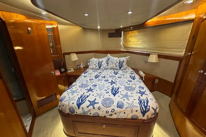 Baby Girl Yacht Photos Pics Luxurious 1999 McKinna 57 Pilothouse bedroom with nautical-themed bedding and elegant wood finishes.