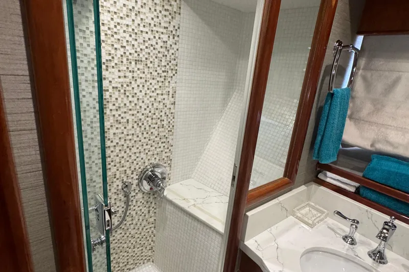 Baby Girl Yacht Photos Pics Luxurious bathroom in 1999 McKinna 57 Pilothouse yacht with modern shower and elegant fixtures.