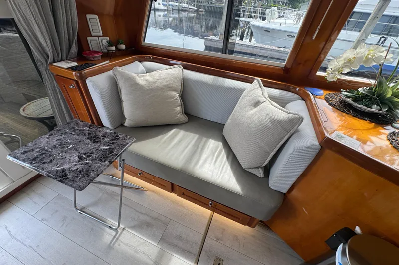 Baby Girl Yacht Photos Pics Interior of 1999 McKinna 57 Pilothouse with cozy seating and marble table.