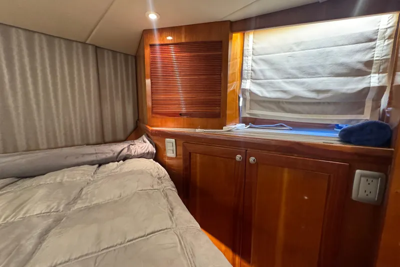 Baby Girl Yacht Photos Pics Cozy cabin interior of 1999 McKinna 57 Pilothouse with wood cabinetry and soft bedding.