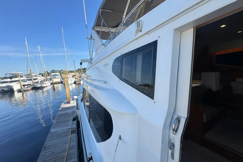 Baby Girl Yacht Photos Pics 1999 McKinna 57 Pilothouse yacht docked at marina under clear blue sky.