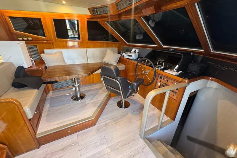 Baby Girl Yacht Photos Pics 1999 McKinna 57 Pilothouse interior with helm, seating, and wooden accents.