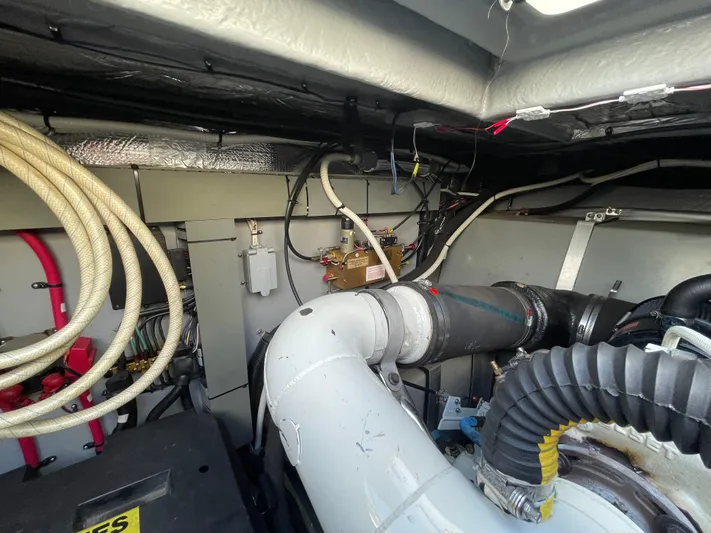 Limin Yacht Photos Pics Engine room of a 2000 Sea Ray 460 Sundancer with visible pipes and wiring.