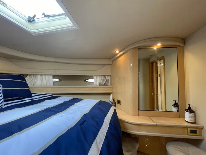 Limin Yacht Photos Pics Luxurious cabin interior of 2000 Sea Ray 460 Sundancer with striped bedding and vanity.