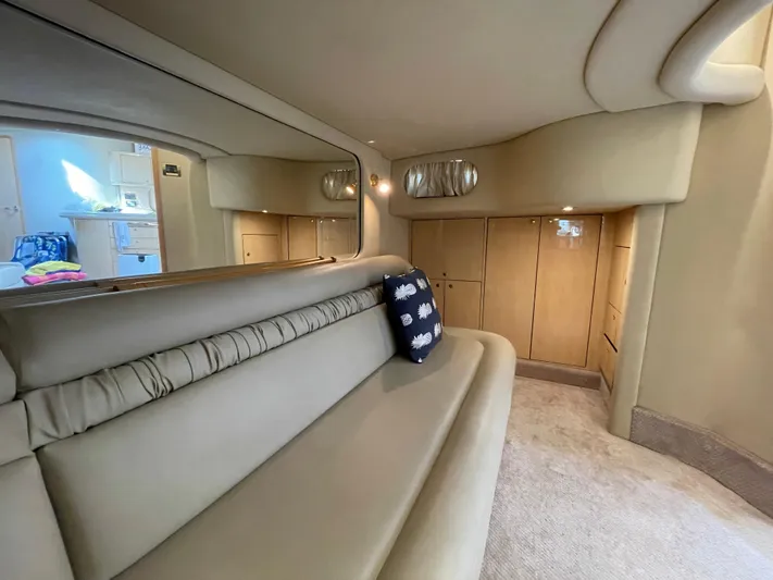 Limin Yacht Photos Pics Interior of 2000 Sea Ray 460 Sundancer yacht with beige seating and wooden cabinets.