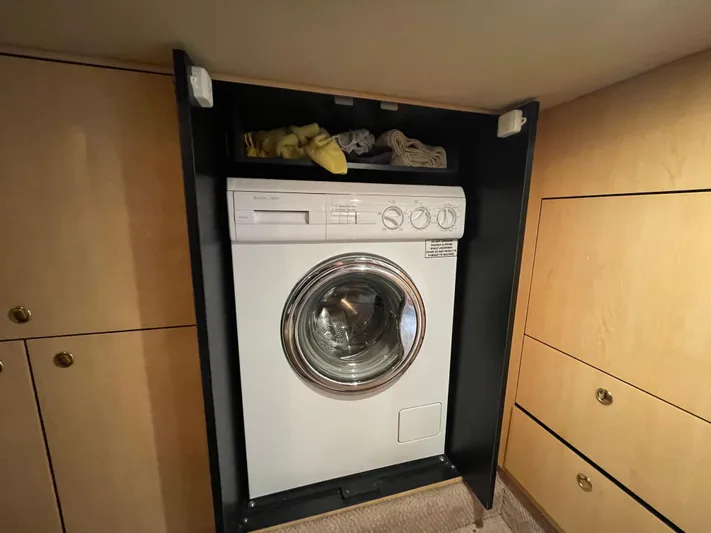 Limin Yacht Photos Pics Washing machine inside 2000 Sea Ray 460 Sundancer yacht cabin with wooden cabinetry.