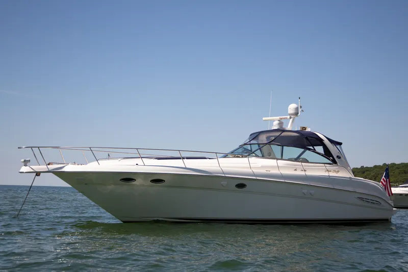 Limin Yacht Photos Pics 2000 Sea Ray 460 Sundancer yacht on calm water under clear blue sky.